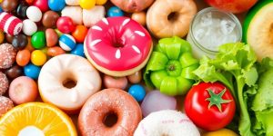 Colorful sweets and healthy foods depicting sugar's gut health effects.