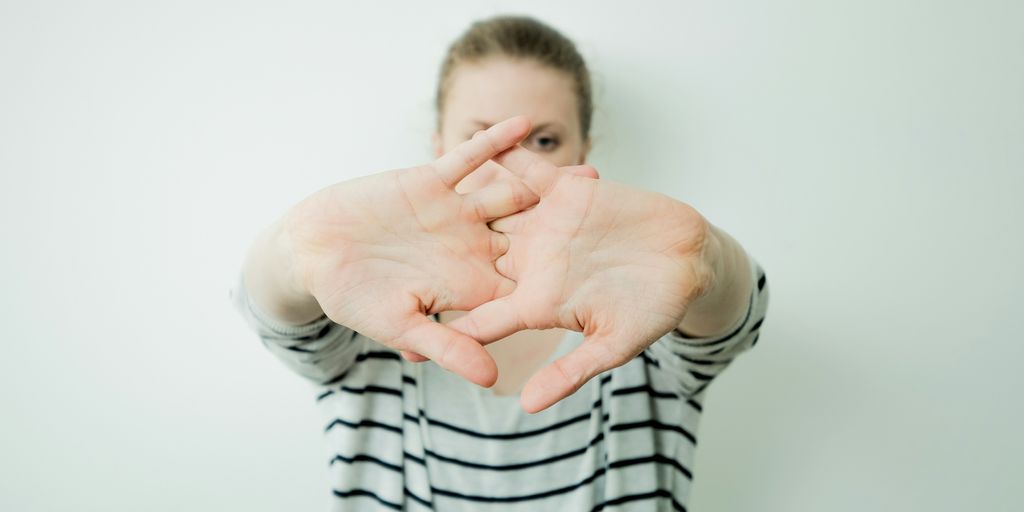a woman making a heart with her hands